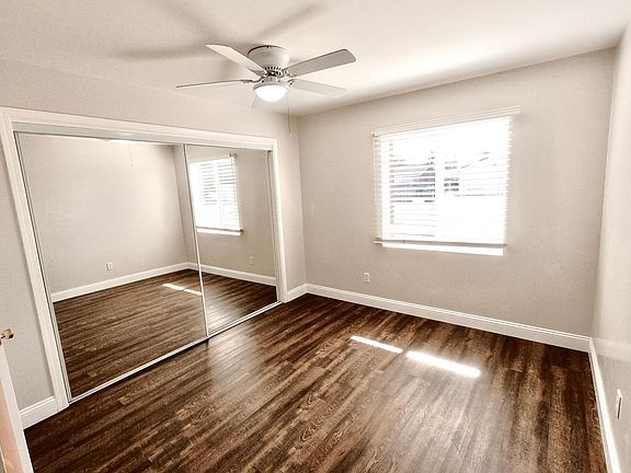 Bedroom 1 with mirrored closet doors, makes the room feel spacious and bright.