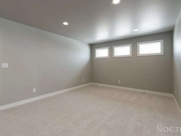 Bonus room off the stairs. Doorway in the corner leads to master bedroom. (Photo of another unit with similar finishes and quality.)