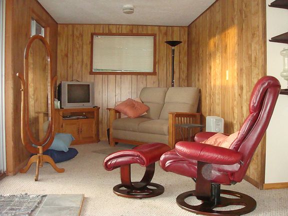 Looking towards the south end of the living room.  Access to the west view/entertainment deck through sliding glass doors.  Deck offers stairs down to the beach area.
