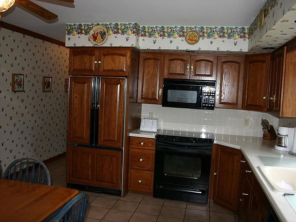 Redone Kitchen with Corian counters and tile floors 