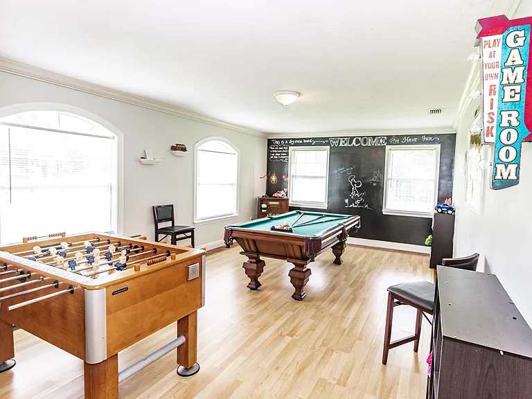 Game room with foosball, pool table, toys.
