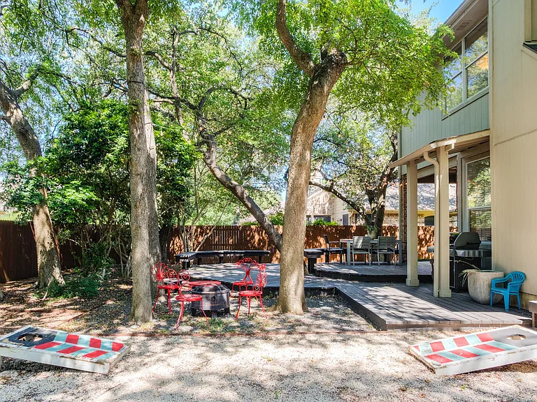 Large outdoor area with fire pit, grill and deck space.