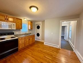 Eat-in kitchen with fridge, 
stove, microwave, washer/dryer.