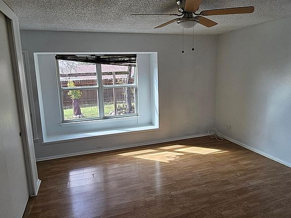 Master bedroom with bay window. Wood floors