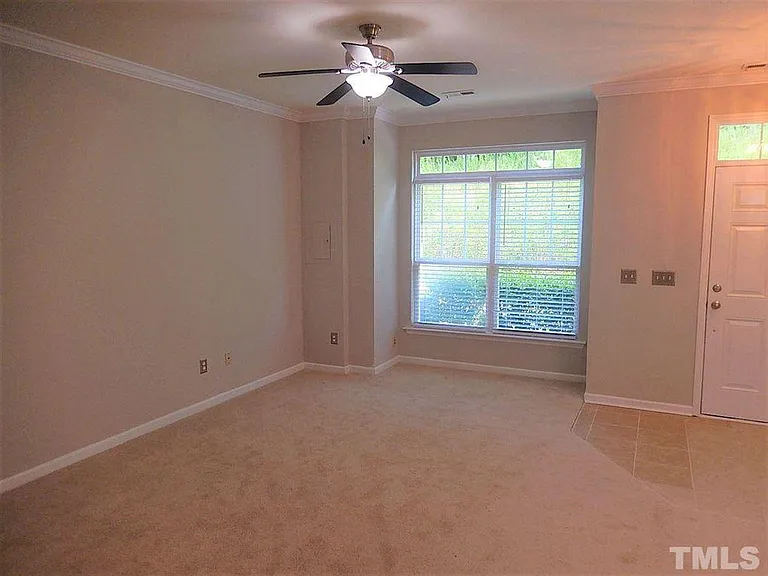 Large Bright Living Room accomodates large furniture with a private wooded view.