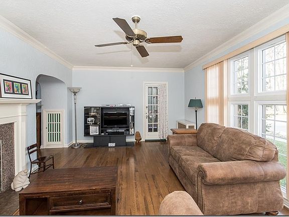 Living Room a fireplace, ceiling fan and door to screen porch area