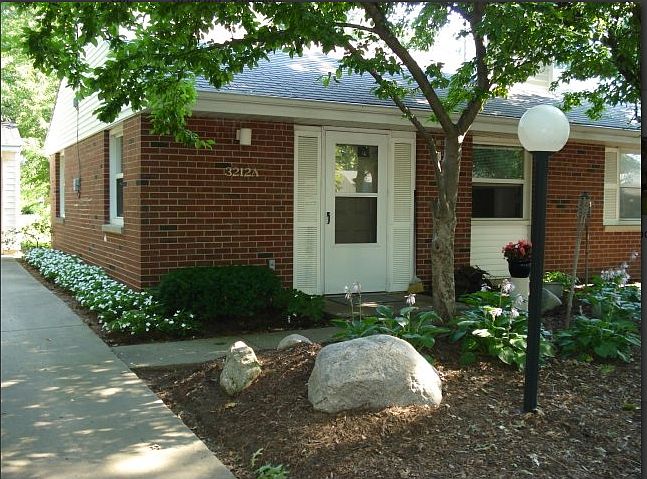 Duplex showing detached garage