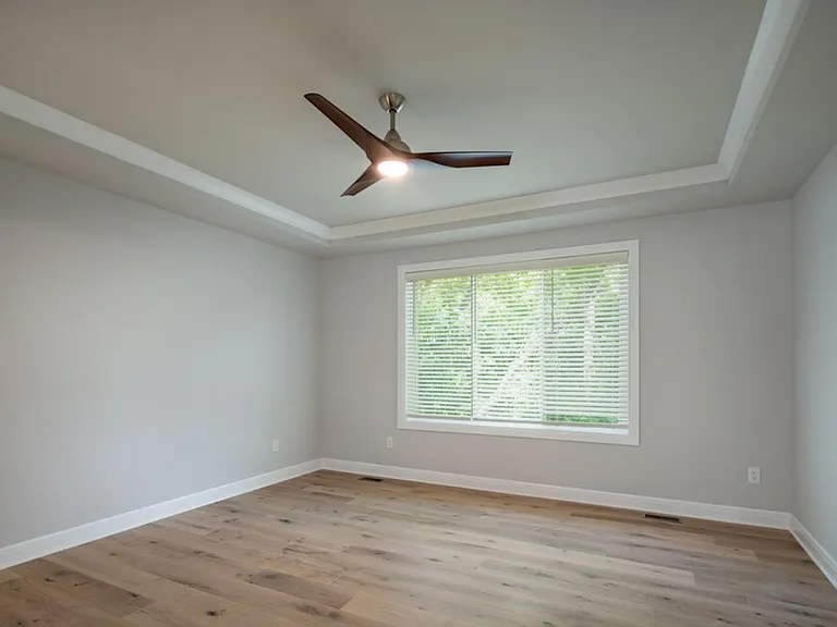 Expansive First Floor Primary Suite with Tray Ceiling and Ceiling Fan