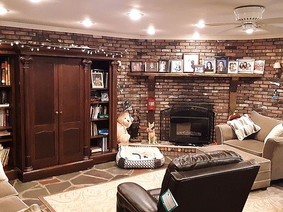 Large living room open to dining room with fireplace slate floor and wet bar