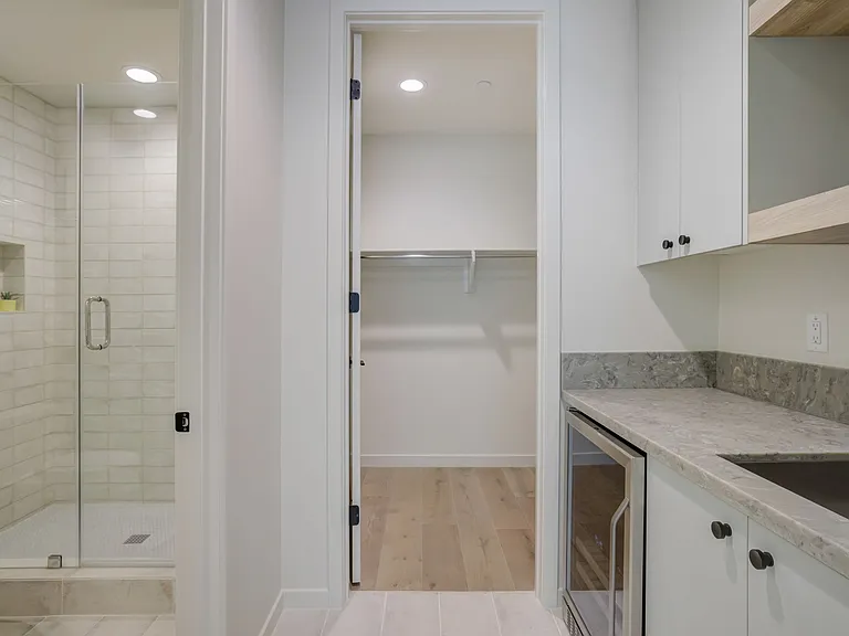 Private-entry guest suite featuring a kitchenette, walk-in closet, and full bathroom.