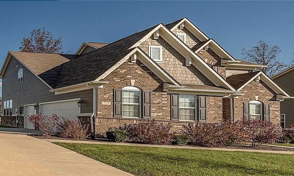 Front view of home with side load 3 car finished garage.