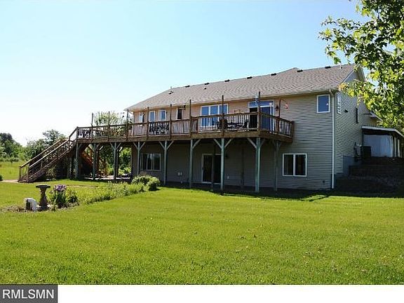 Walkout access to lawn, trees, native tall prairie grass and pond