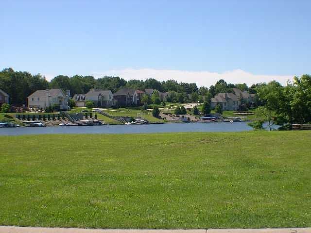 View of 12951 Rocky Pointe from the street thru the lot toward the water.