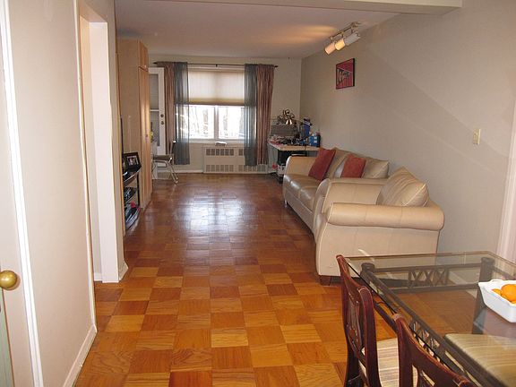 Large living room with double hall closet and hardwood flooring throughout.
