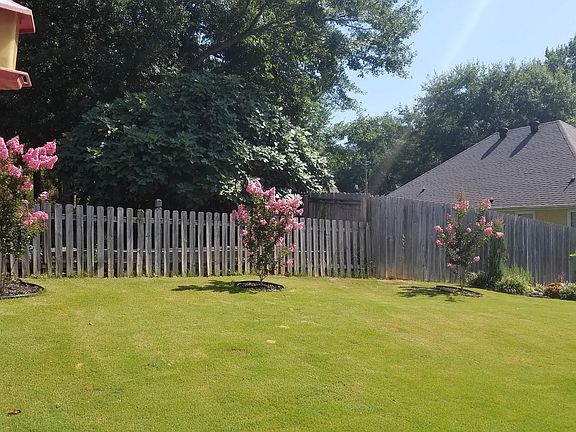 huge back yard with beautiful plants. Plenty of room for vegetable garden!