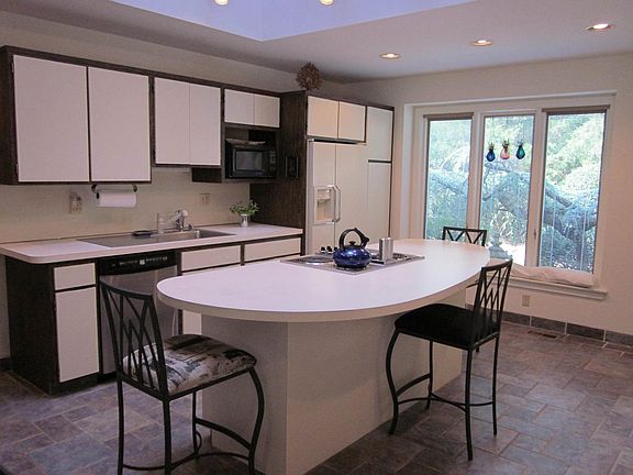 Spacious island kitchen has adjoining laundry room
