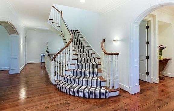 Entry with new carpeting on the stairs and beautiful wood floors.