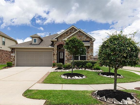 The front of the home has excellent curb appeal with extensive landscaping and a stone elevation. The home sits on a large corner lot.