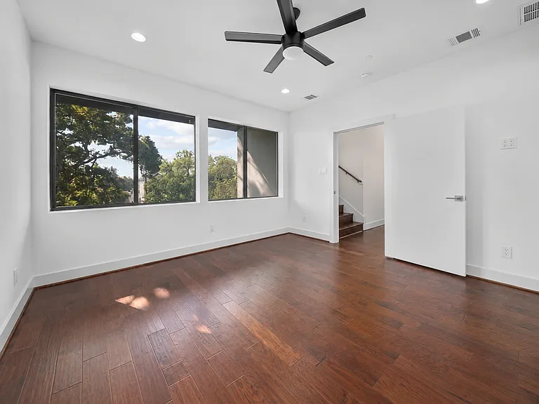 Unfurnished primary bedroom with large expansive windows to allow natural sunlight