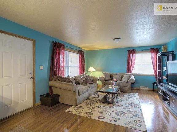 Nicely sized living room has beautiful hardwood floors