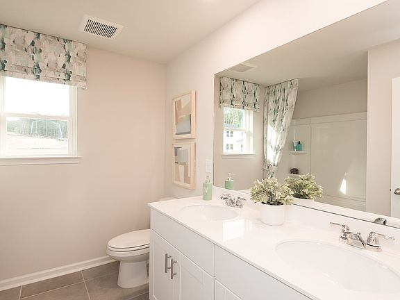 Mornings are a breeze with dual sinks in the upstairs secondary bathroom.