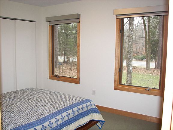 Closets the entire length of the wall provide ample storage in this bedroom.