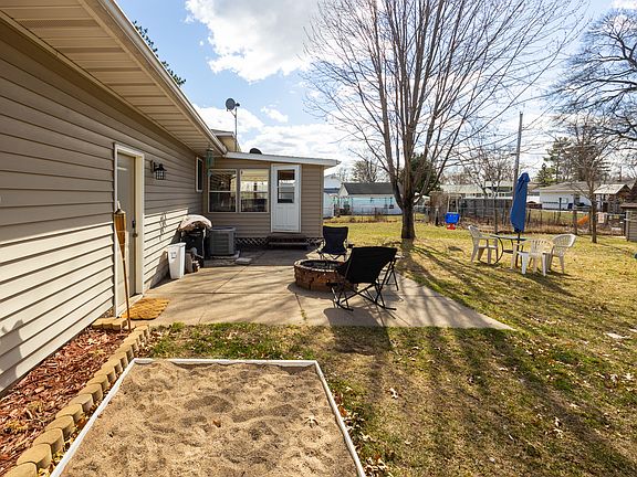 fire pit and fenced in backyard