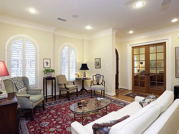 Enter this home through the beautiful Arched Door. Notice the arched windows with custom plantation 