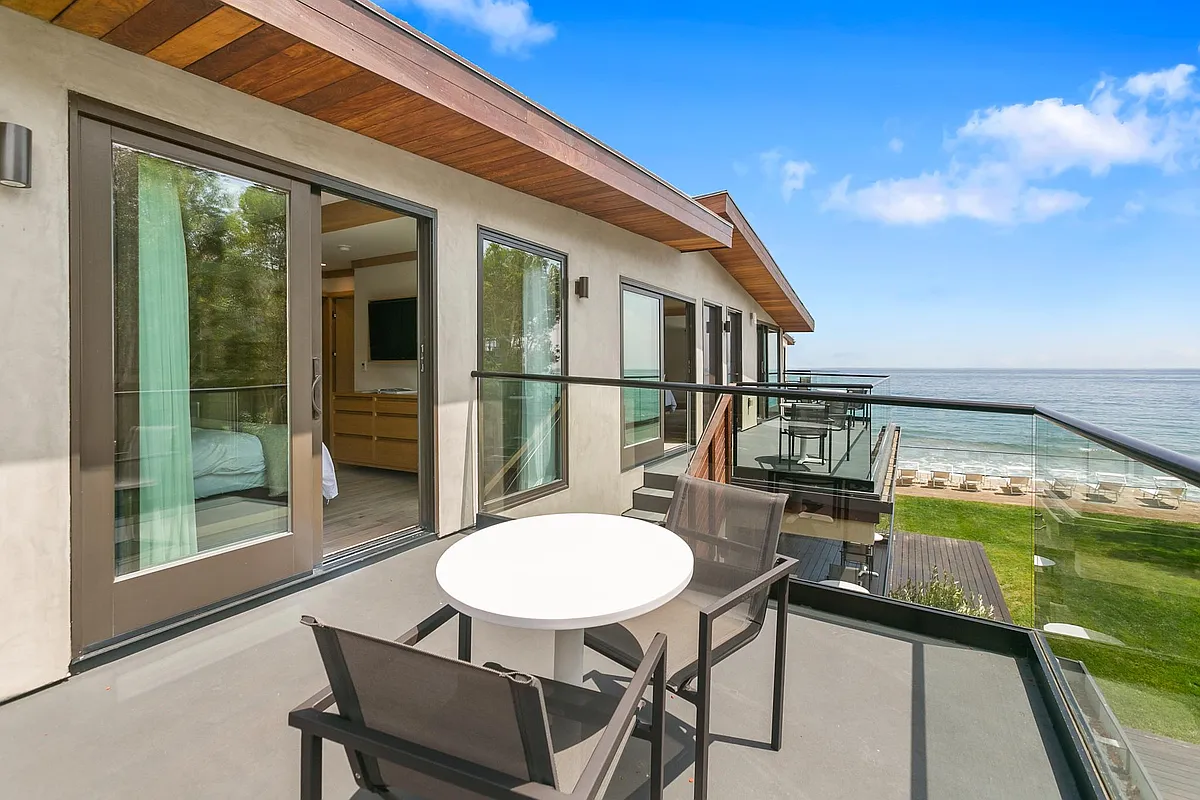 Private outdoor balcony with dining chairs and table. - 22648 E Pacific Coast Hwy #9