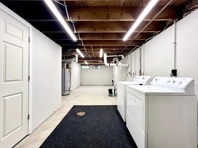 Bright and clean laundry area with tons of unfinished storage. 50 gallon water heater.