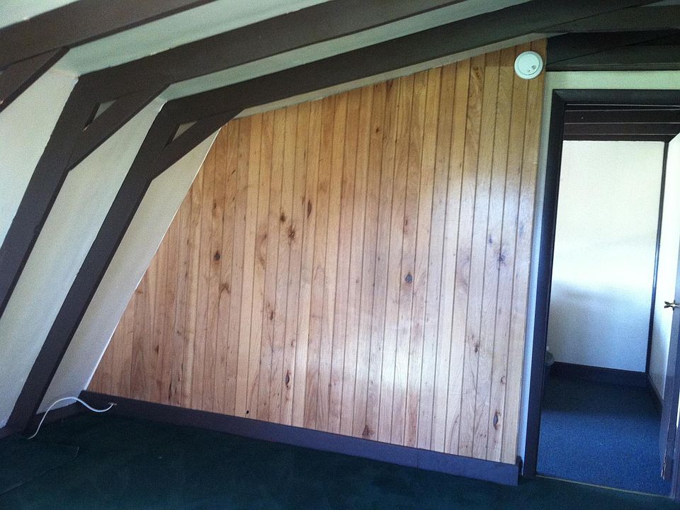 One view of the living room, with the entrance to the smaller bedroom seen