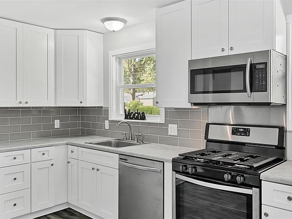 Updated Kitchen has new cabinets, tile back splash, new stainless steel appliances