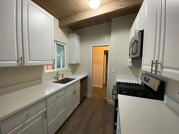 New quartz counters, sink and new kitchen flooring. Gas stove, dishwashers, loads of cabinets.