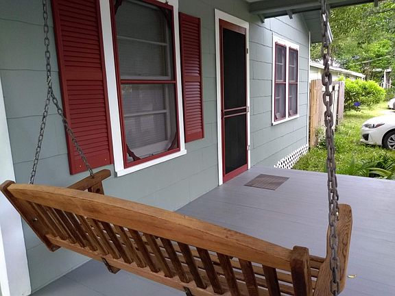 Wooden front porch swing.