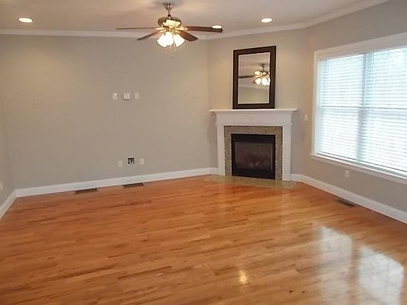 Living room with large windows, fan and gas FP