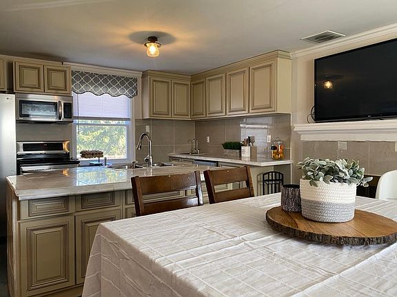 Eat-in dining, open concept w/ door out to sunroom.