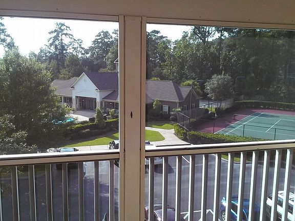 Screened in porch overlooking pool and tennis court