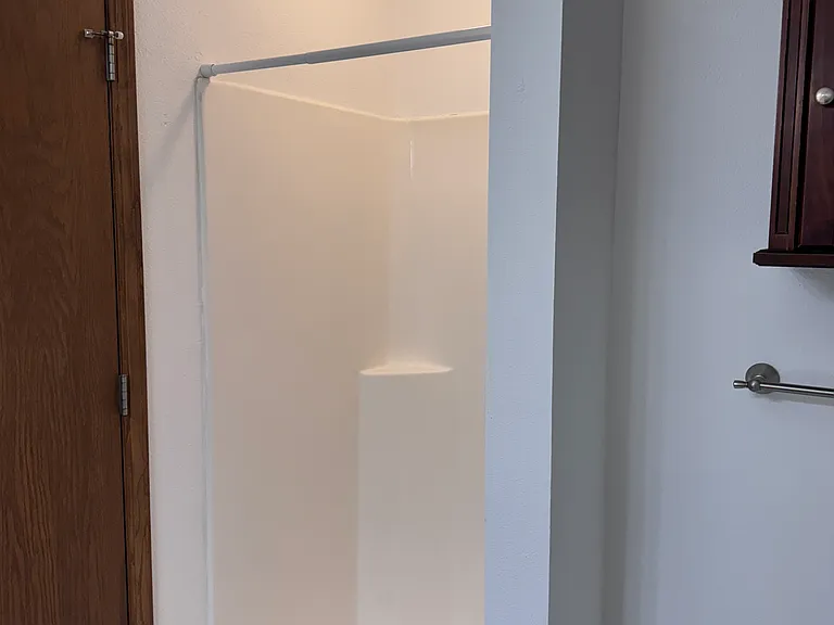 Large bathroom with a garden tub and a separate shower stall.