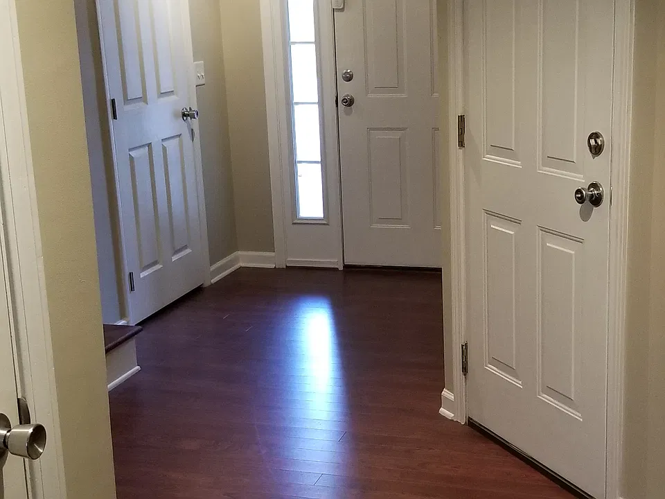 FRONT FOYER WITH STORAGE ON LEFT, HALF BATH/LAUNDRY ON THE RIGHT AND ALSO DOOR TO GARAGE