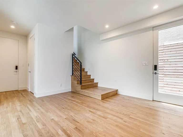 Foyer offers access to back area of proeprty as well