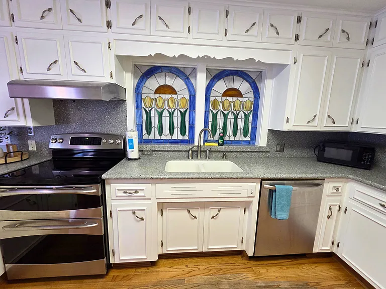 Enjoy cooking with the kitchen's stove, oven, and range hood