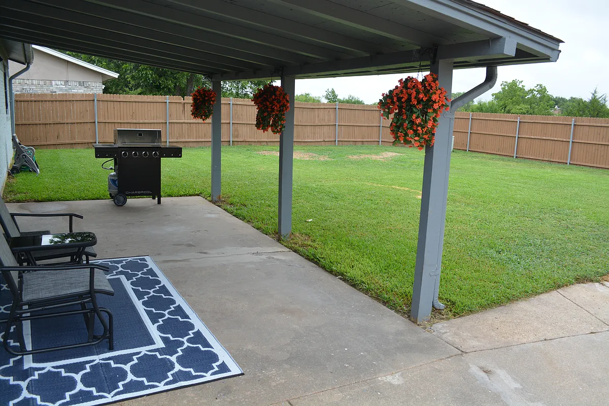 Covered patio area with outdoor furniture and a BBQ grill. - 3100 Valley Forge Trl