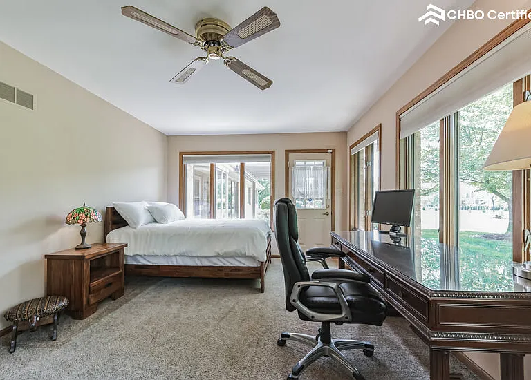 Bedroom 4 - windows on 3/4 walls, executive desk
