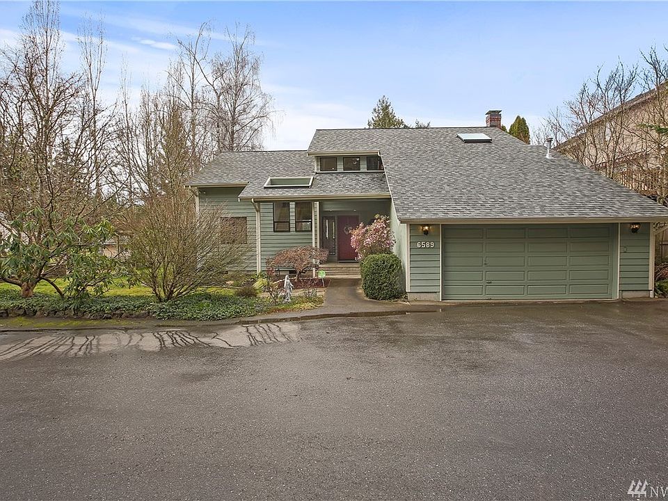 Front of home.  Imagine the colors when Spring blooms.  Note windows and skylights everywhere.