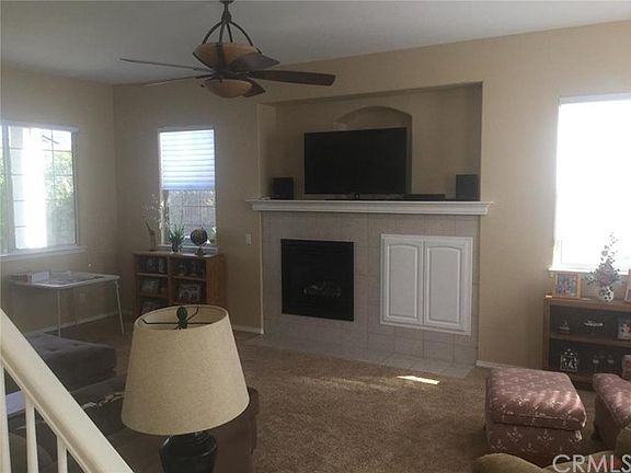 Living Room with fireplace and niche and ceiling fan