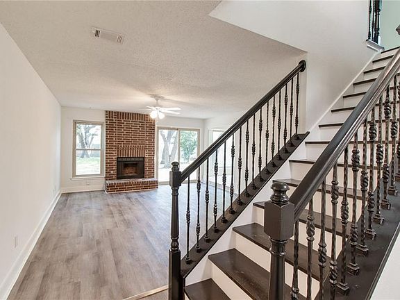 Entrance showing stairs the lead up to second living area, three bedrooms and one full bath