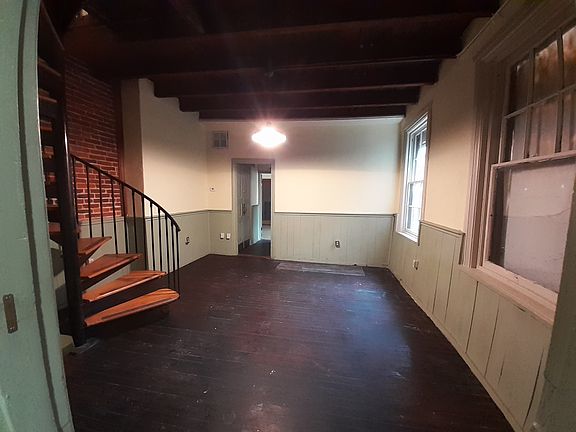 Living room and spiral staircase to second floor