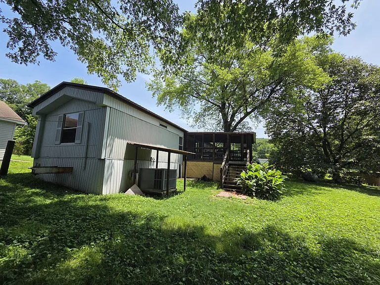View of backyard with screened in porch and stairs and HVAC unit