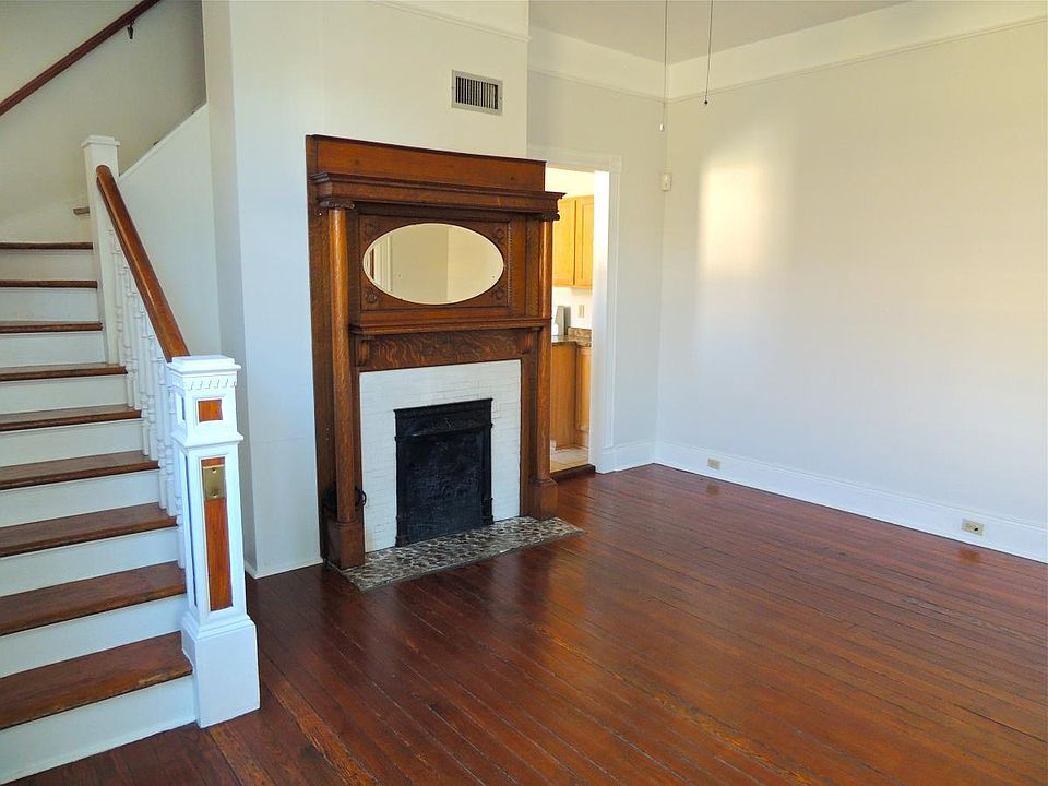 Living room from front door. Stunning original fireplace and