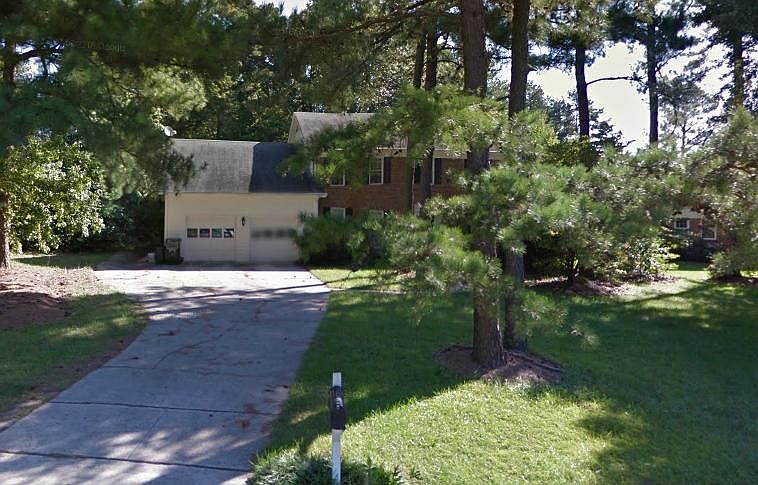 All brick house, front and back with lots of trees.